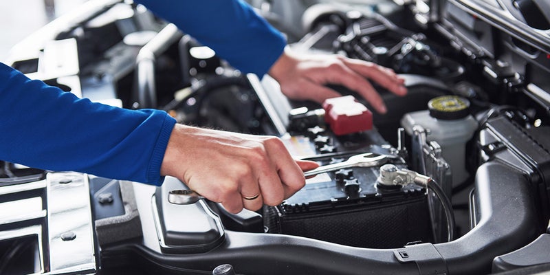 Service technician working on a car engine - Jerry's Buick GMC in Weatherford TX